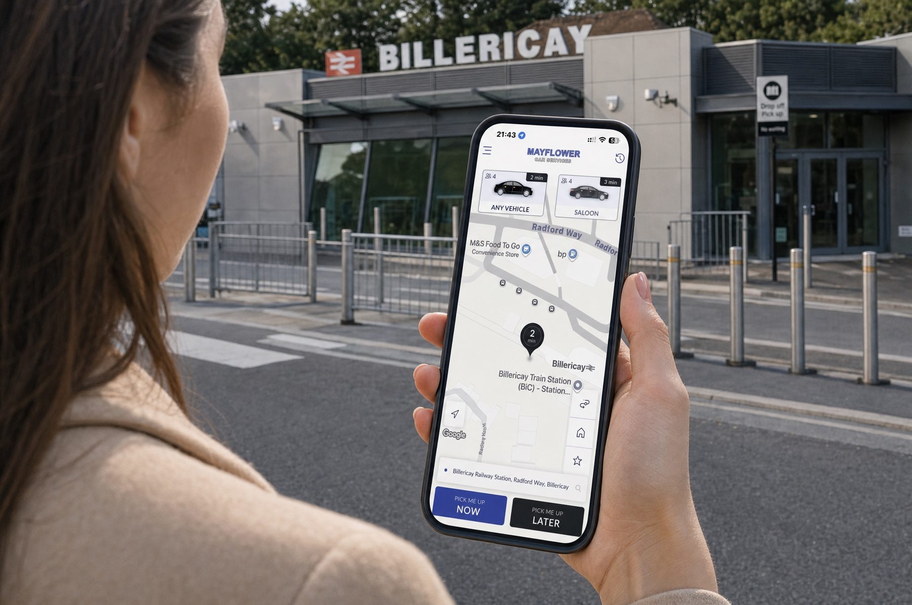 Booking a taxi on a phone outside a station