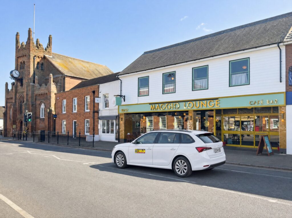 Taxi driving along a high street
